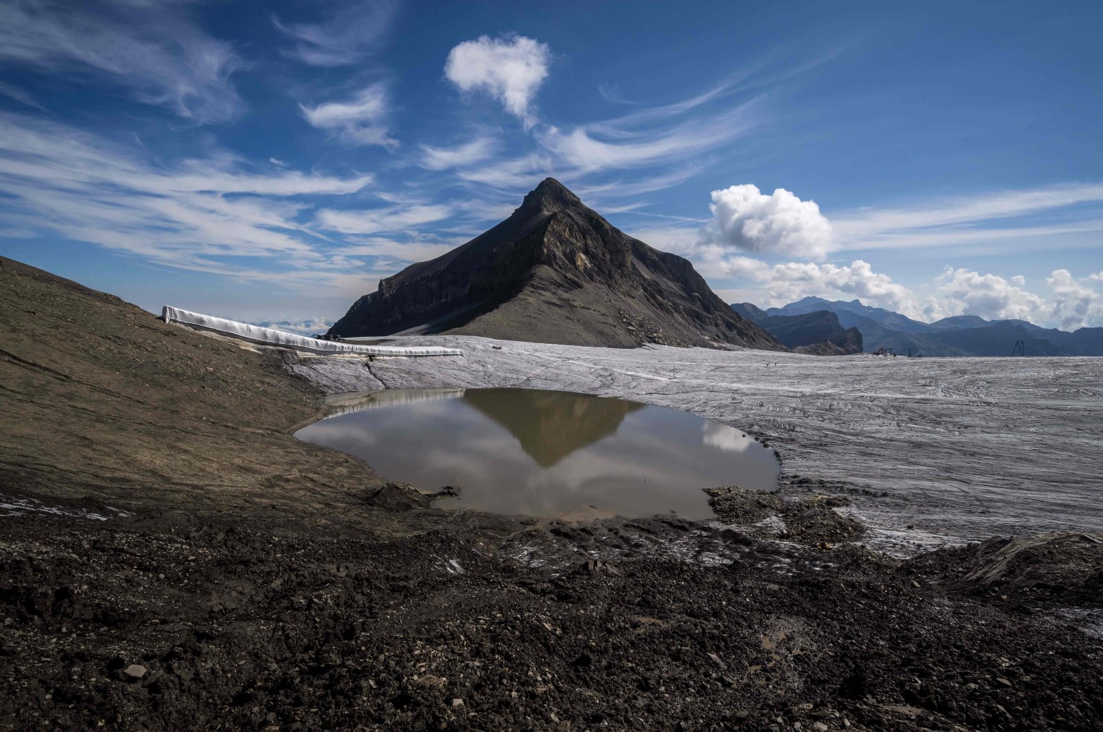 A picture taken on Aug. 6, 2022, shows The Oldenhorn mountain next to the melting Tsanfleuron Glacier above Les Diablerets, Switzerland. Following several heat waves blamed by scientists on climate change, Switzerland is seeing its alpine glaciers melting at an increasingly rapid rate. (AFP Photo)