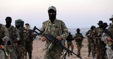 Türkiye-backed Syrian fighters man a military position on the outskirts of the town of Kuljibrin, in the country's northern Aleppo governorate, facing positions of the YPG-controlled area of Tal Rifaat, Syria, July 27, 2022. (AFP Photo)