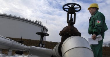 An engineer of the Hungarian Oil and Gas Company (MOL) checks the receiving area of the Druzhba oil pipeline in the country's largest oil refinery in Szazhalombata, south of Budapest, Hungary, Jan. 9, 2007. (AP Photo)