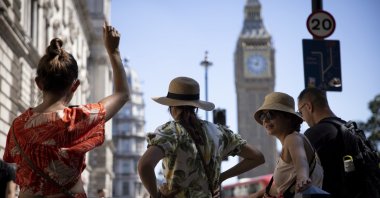 People wear hats as a precaution against the hot weather in Westminster, London, U.K., Aug. 11, 2022. (EPA Photo)