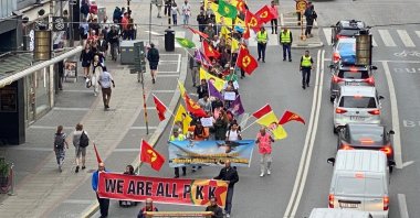 PKK/YPG terrorist sympathizers carrying portraits of PKK leader and so-called flags of the terrorist group march in Stockholm, Sweden, July 27, 2022. (AA File Photo)