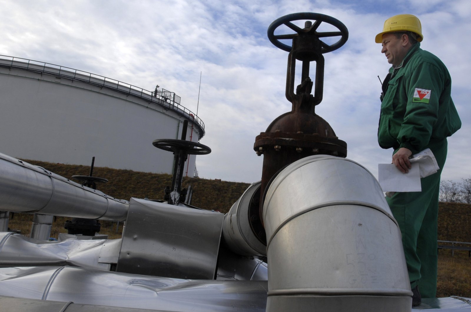 An engineer of the Hungarian Oil and Gas Company (MOL) checks the receiving area of the Druzhba oil pipeline in the country&#039;s largest oil refinery in Szazhalombata, south of Budapest, Hungary, Jan. 9, 2007. (AP Photo)
