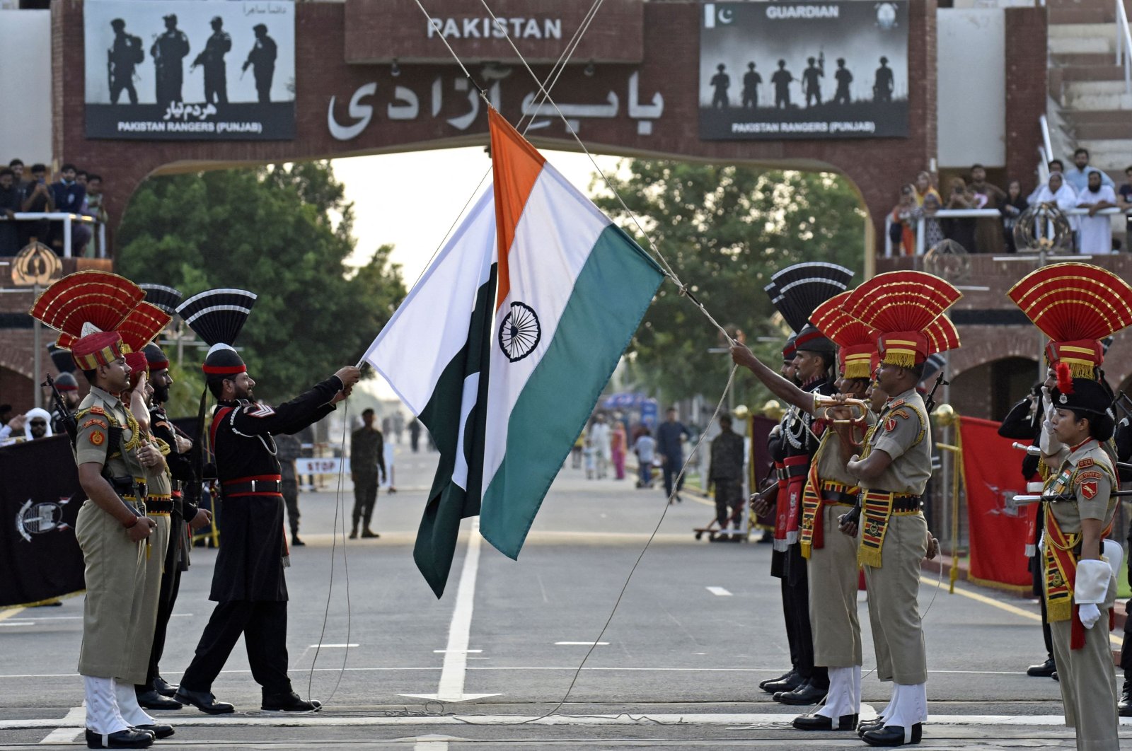 Indian Border Security Force (BSF) soldiers (in brown) and Pakistani Rangers take part in the Beating the Retreat ceremony at the India-Pakistan Wagah border post, about 35 kilometers from Amritsar, India, Aug. 1, 2022. (AFP Photo)