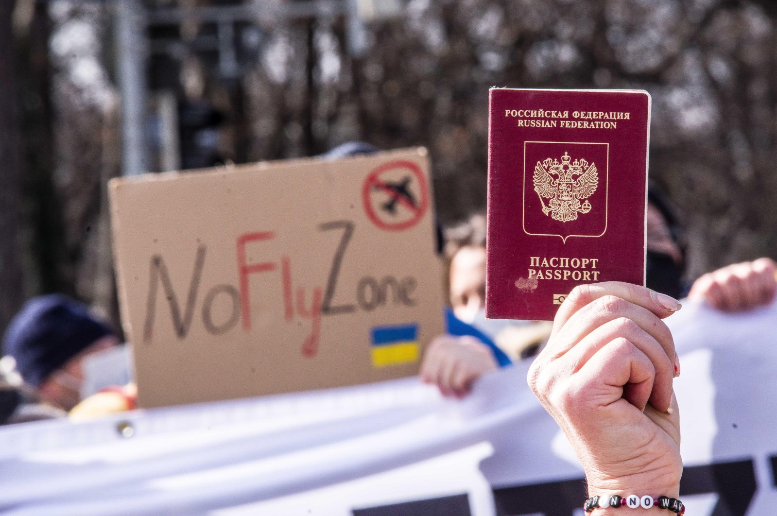 Russian citizen Irina Revina Hofmann (R) holds up her Russian passport during a demonstration against the war in Ukraine to ask for forgiveness and express not all Russians are part of the Kremlin&#039;s war and authoritarianism, Munich, Germany, March 5, 2022. (ZUMA Press Wire via Reuters)