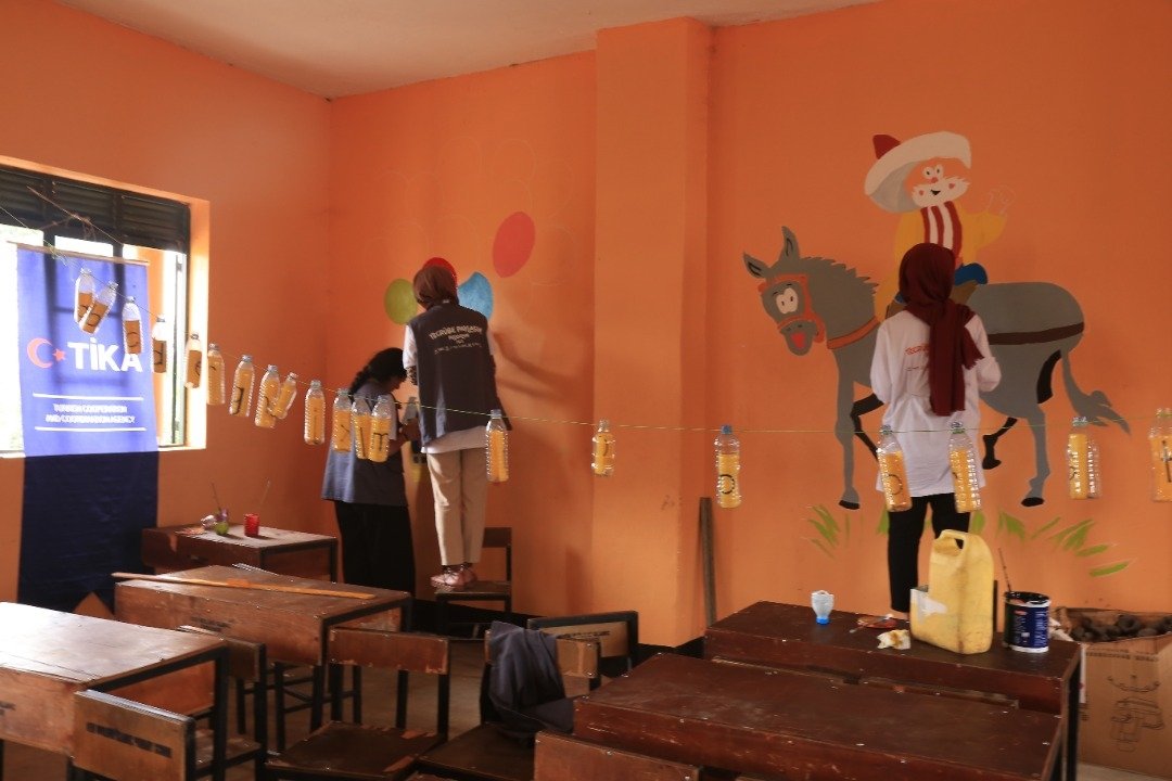 Students paint the walls of the orphanage, in Luweroo, Uganda, Aug. 13, 2022. (AA Photo)