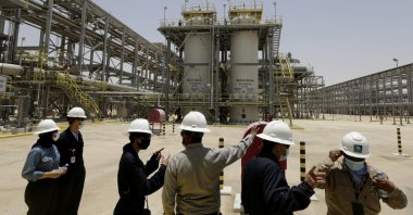 Saudi Aramco engineers and journalists look at the Hawiyah Natural Gas Liquids Recovery Plant in Hawiyah, in eastern Saudi Arabia, June 28, 2021. (AP Photo)