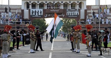 Indian Border Security Force (BSF) soldiers (in brown) and Pakistani Rangers take part in the Beating the Retreat ceremony at the India-Pakistan Wagah border post, Amritsar, India, Aug. 1, 2022. (AFP Photo)