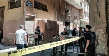 Security personnel stand at the cordoned scene of a fire in Giza, Egypt, Aug. 14, 2022. (Reuters Photo)