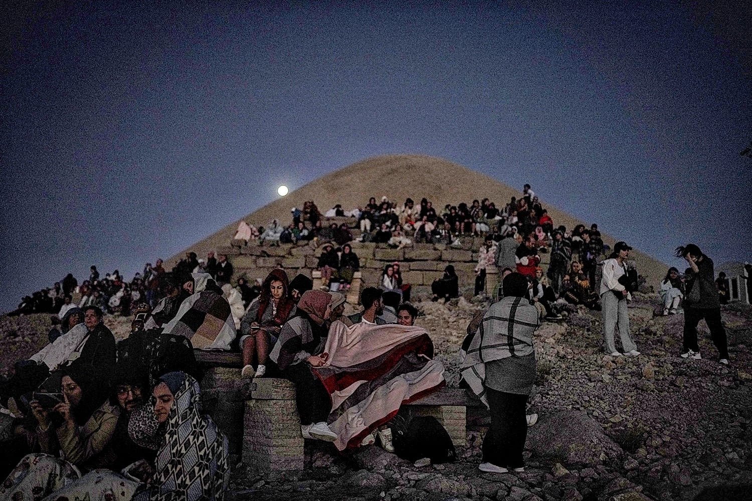 People watch the night sky on Mount Nemrut, Adıyaman, Türkiye, Aug. 11, 2022. (Photo by Uğur Yıldırım)