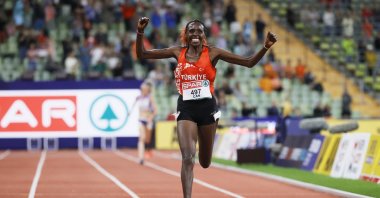 Yasemin Can of Tükiye celebrates as she crosses the finish line to win the women's 10,000 meters final during the athletics events at the European Championships Munich 2022, Munich, Germany, Aug. 15, 2022. (EPA Photo)