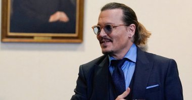 Actor Johnny Depp gestures to spectators in court after closing arguments during his defamation case against ex-wife Amber Heard at the Fairfax County Circuit Courthouse in Fairfax, Virginia, U.S., May 27, 2022. (REUTERS)