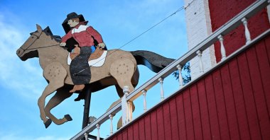 A cowboy on horseback is displayed outside of The Wrangler building in Cheyenne, Wyoming, U.S., on Aug. 12, 2022. (AFP Photo)
