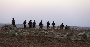 Turkey-backed Syrian fighters man a military position on the outskirts of the town of Kuljibrin, in the country's northern Aleppo governorate, facing positions of the YPG-controlled area of Tal Rifaat, on July 27, 2022. (AFP)