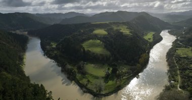 The lower reaches of the Whanganui River flow near the Kaiwhaiki settlement in New Zealand, June 15, 2022. (AP Photo)