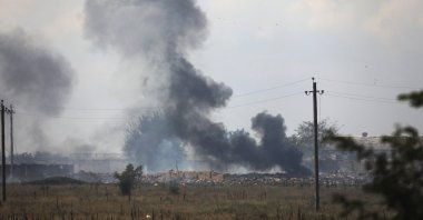 Smoke rises over the site of an explosion at a Russian ammunition storage facility near the village of Mayskoye, Crimea, Aug. 16, 2022. (AP Photo)