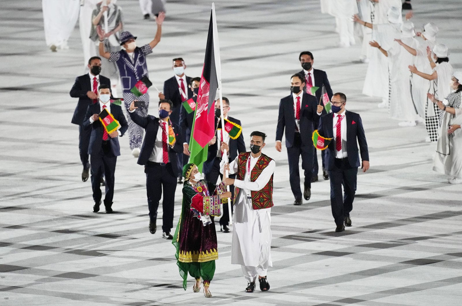 Afghanistan&#039;s Kimia Yousofi, front left, and Farzad Mansouri carry their country&#039;s flag at the Tokyo 2020 opening ceremony, Tokyo, Japan, July 23, 2021. (AP Photo)