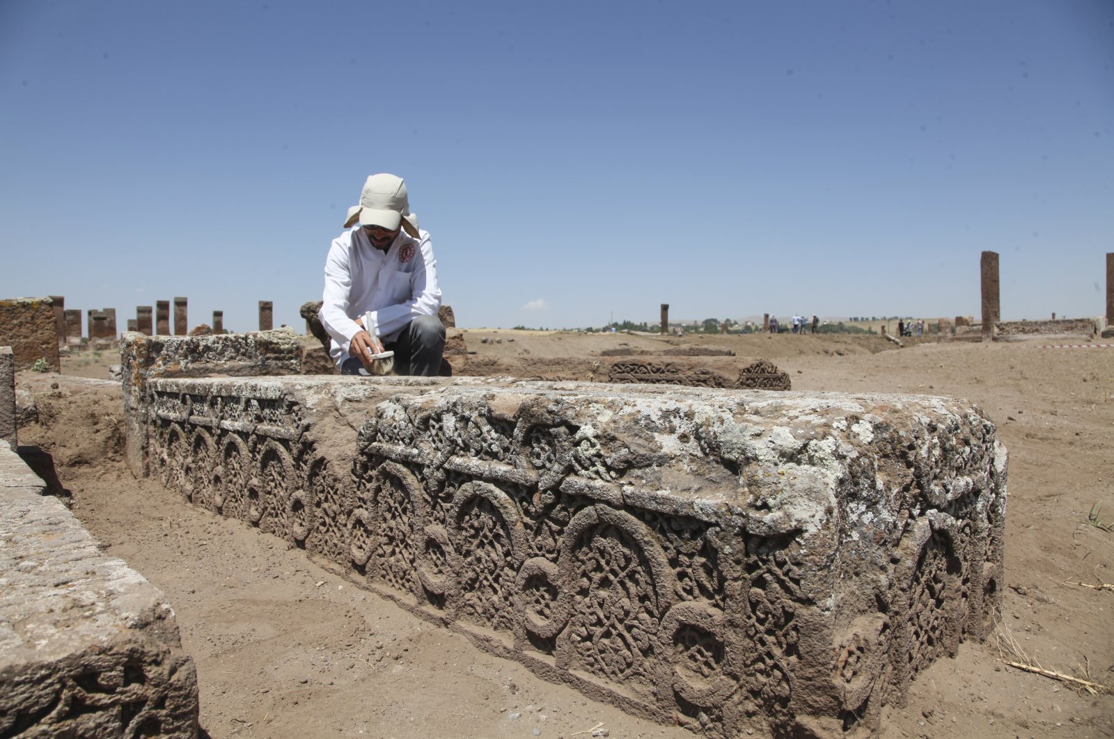 An archaeologists works on a newly discovered cenotaph at the Ahlat Seljuk Meydan Cemetery, Bitlis,  eastern Türkiye, Aug. 16, 2022. (AA) 