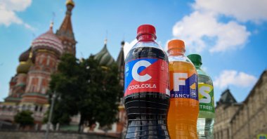 Bottles of soft drinks CoolCola, Fancy and Street, with their names and designs resembling Coca-Cola, Fanta and Sprite – the iconic brands of U.S. beverage giant Coca-Cola, are pictured in front of St. Basil's Cathedral in downtown Moscow, Russia, July 25, 2022. (AFP Photo)