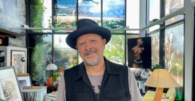Photographer Danny Clinch stands in front of his photographs at the Transparent Clinch Gallery in Asbury Park, New Jersey, U.S., Aug. 12, 2022. (REUTERS)