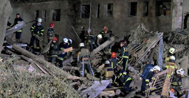Rescue workers inspect the site of a destroyed hostel after a missile strike in Kharkiv, Ukraine, Aug. 17, 2022. (AFP Photo)