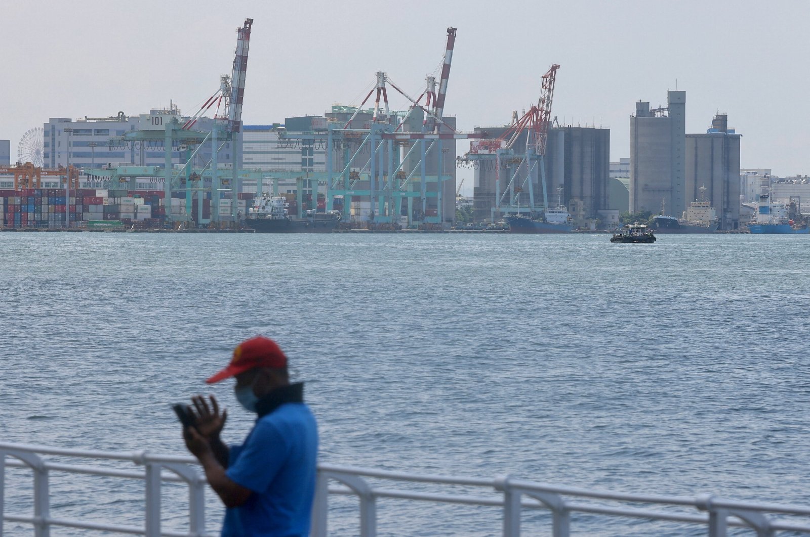 A man look at his phone in front of the port in Kaohsiung, Taiwan, Aug. 5, 2022. (Reuters Photo)