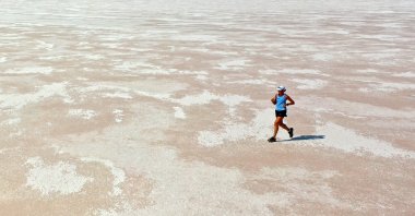 Mina Guli runs on a dry part of Lake Tuz, in Konya, central Türkiye, Aug. 16, 2022. (AA PHOTO)