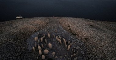 The dolmen of Guadalperal, also known as the Spanish Stonehenge, reemerges after the water receded in the Valdecanas reservoir on the outskirts of El Gordo, Spain, Aug. 3, 2022. (Reuters Photo)