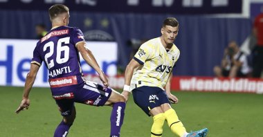 Fenerbahçe's Ezgjan Alioski (R) plays a pass past Austria Wien's Reinhold Ranftl, Vienna, Austria, Aug. 18, 2022. (AA Photo)