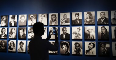 A member of the media takes a photo of a display of various black musical theater actors during a media preview for the exhibition titled "Regeneration: Black Cinema, 1898-1971" at the Academy Museum of Motion Pictures in Los Angeles, California, U.S., Aug. 17, 2022. (EPA Photo)