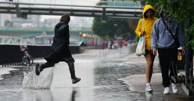 People run in the rain in London, U.K., Aug. 17, 2022. (AP Photo)