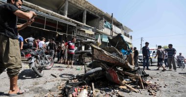 People gather at the sight of a reported regime bombing at a busy market in al-Bab, Syria, Aug.19, 2022. (AFP Photo)