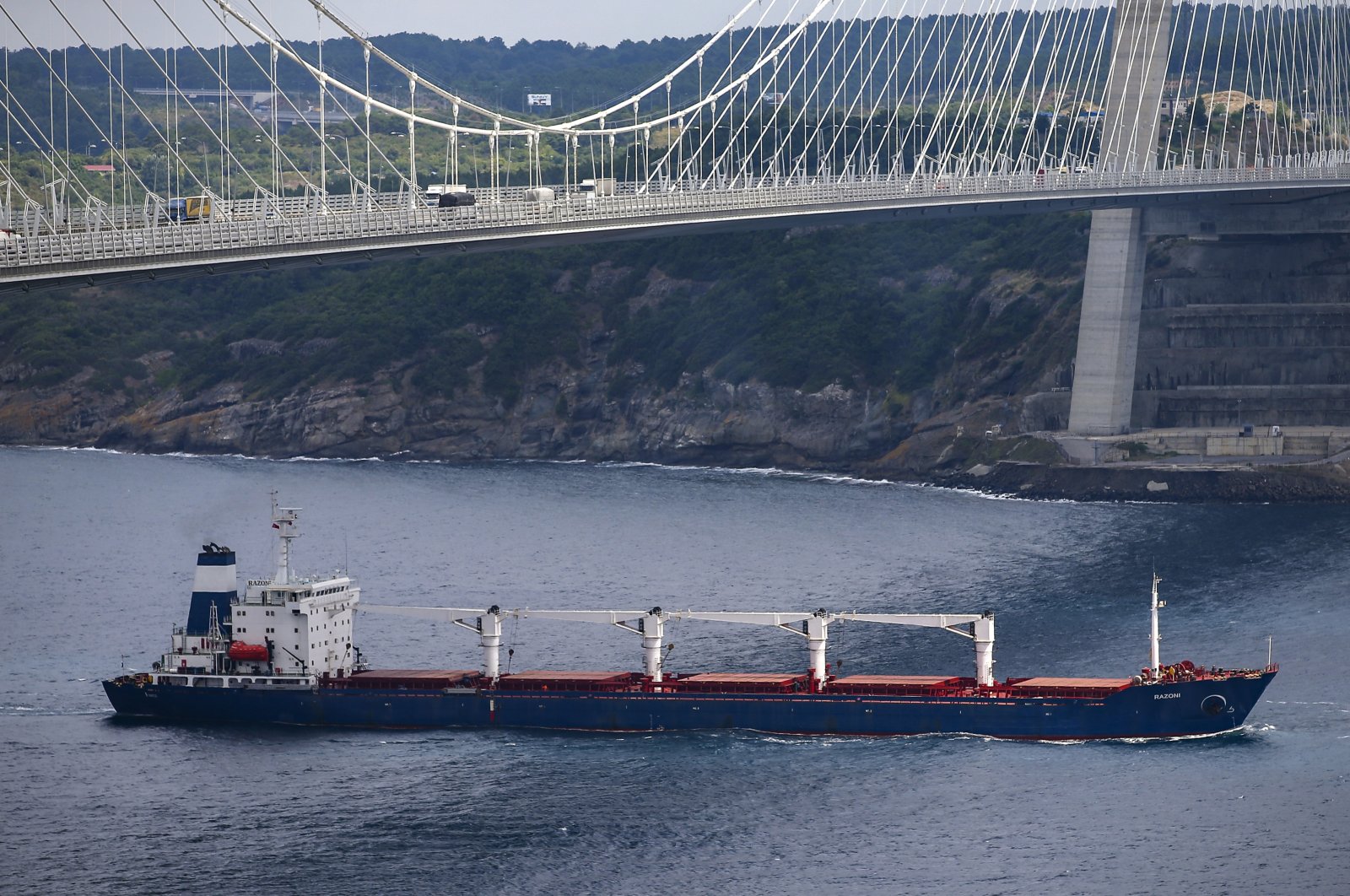 The Sierra Leone-flagged cargo ship Razoni sails under the Yavuz Sultan Selim Bridge after being inspected by Russian, Ukrainian, Turkish and U.N. officials at the entrance of the Bosporus in Istanbul, Turkey, Aug. 3, 2022. (AP Photo)