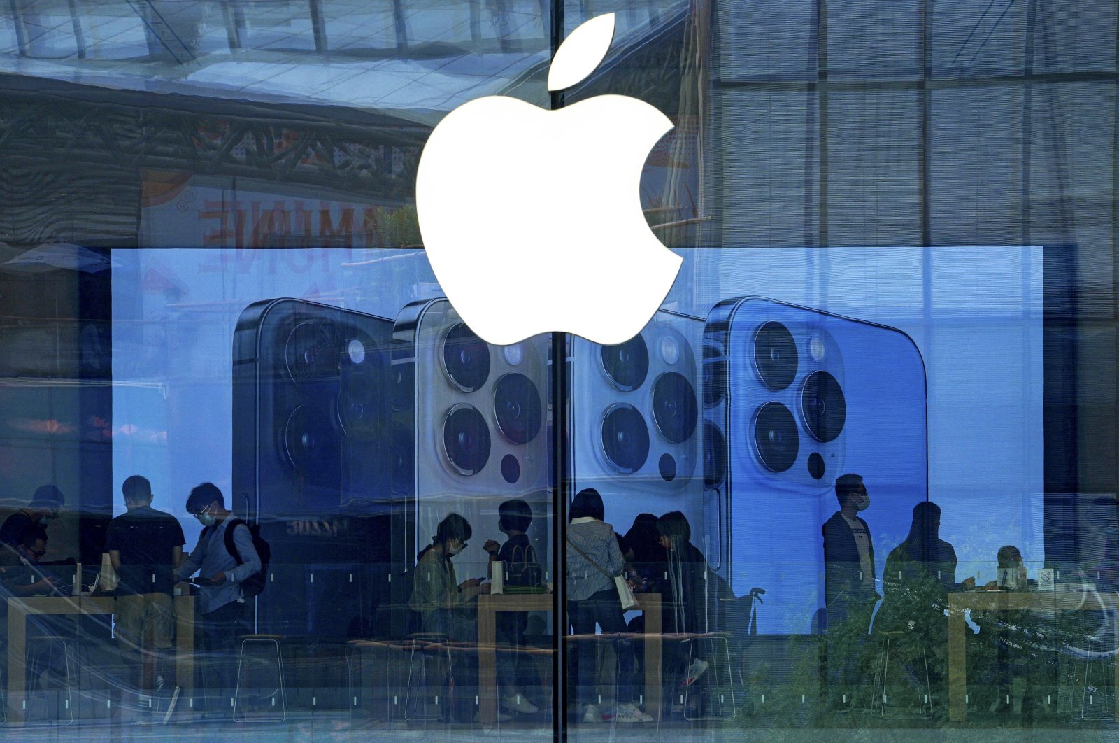 People shop at an Apple Store in Beijing, China, Sept. 28, 2021. (AP Photo)