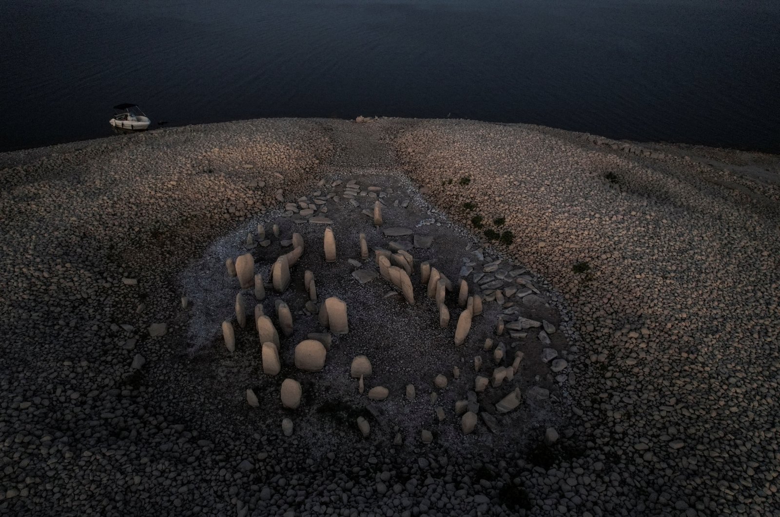The dolmen of Guadalperal, also known as the Spanish Stonehenge, reemerges after the water receded in the Valdecanas reservoir on the outskirts of El Gordo, Spain, Aug. 3, 2022. (Reuters Photo)