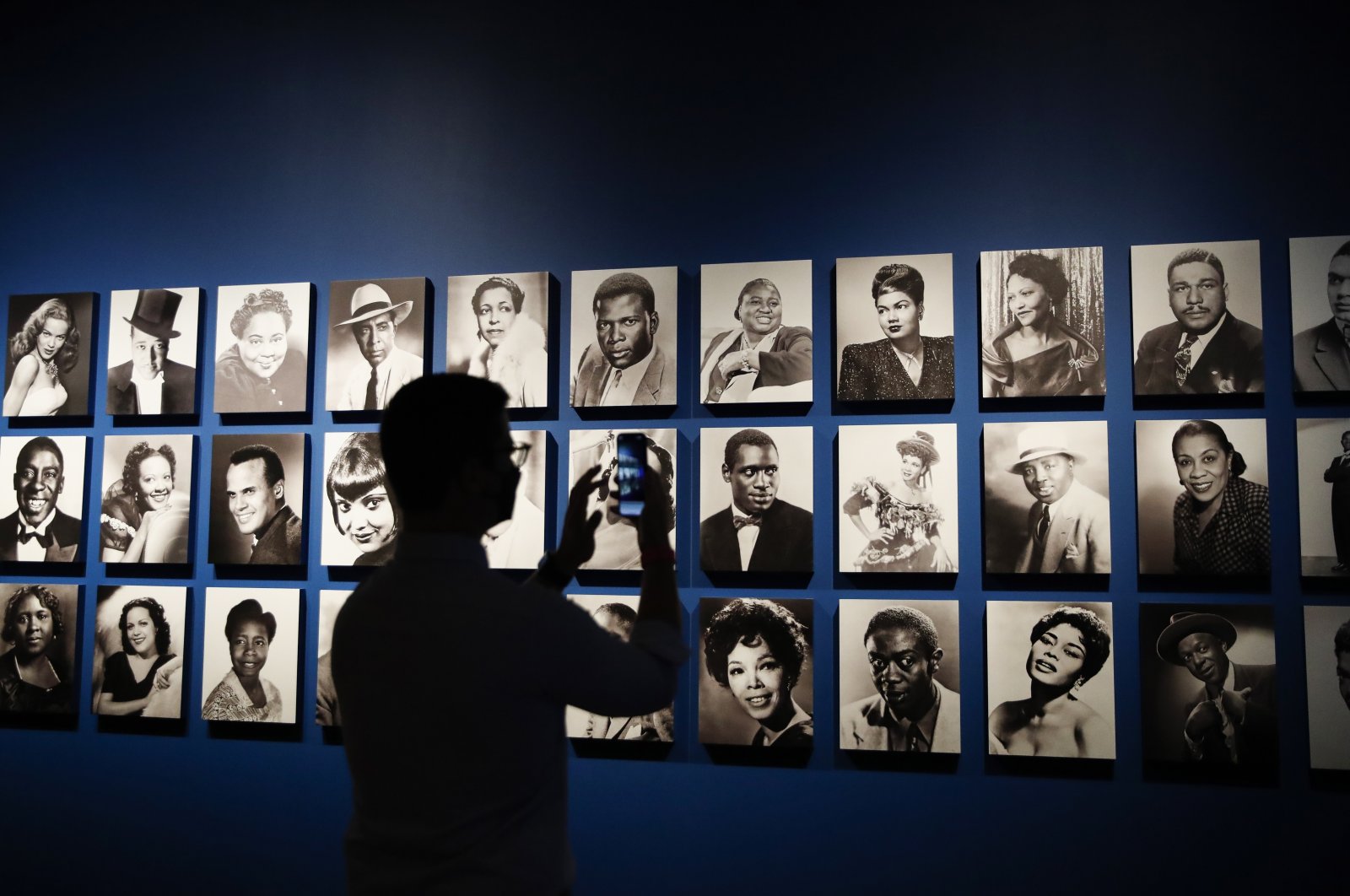 A member of the media takes a photo of a display of various black musical theater actors during a media preview for the exhibition titled &quot;Regeneration: Black Cinema, 1898-1971&quot; at the Academy Museum of Motion Pictures in Los Angeles, California, U.S., Aug. 17, 2022. (EPA Photo)