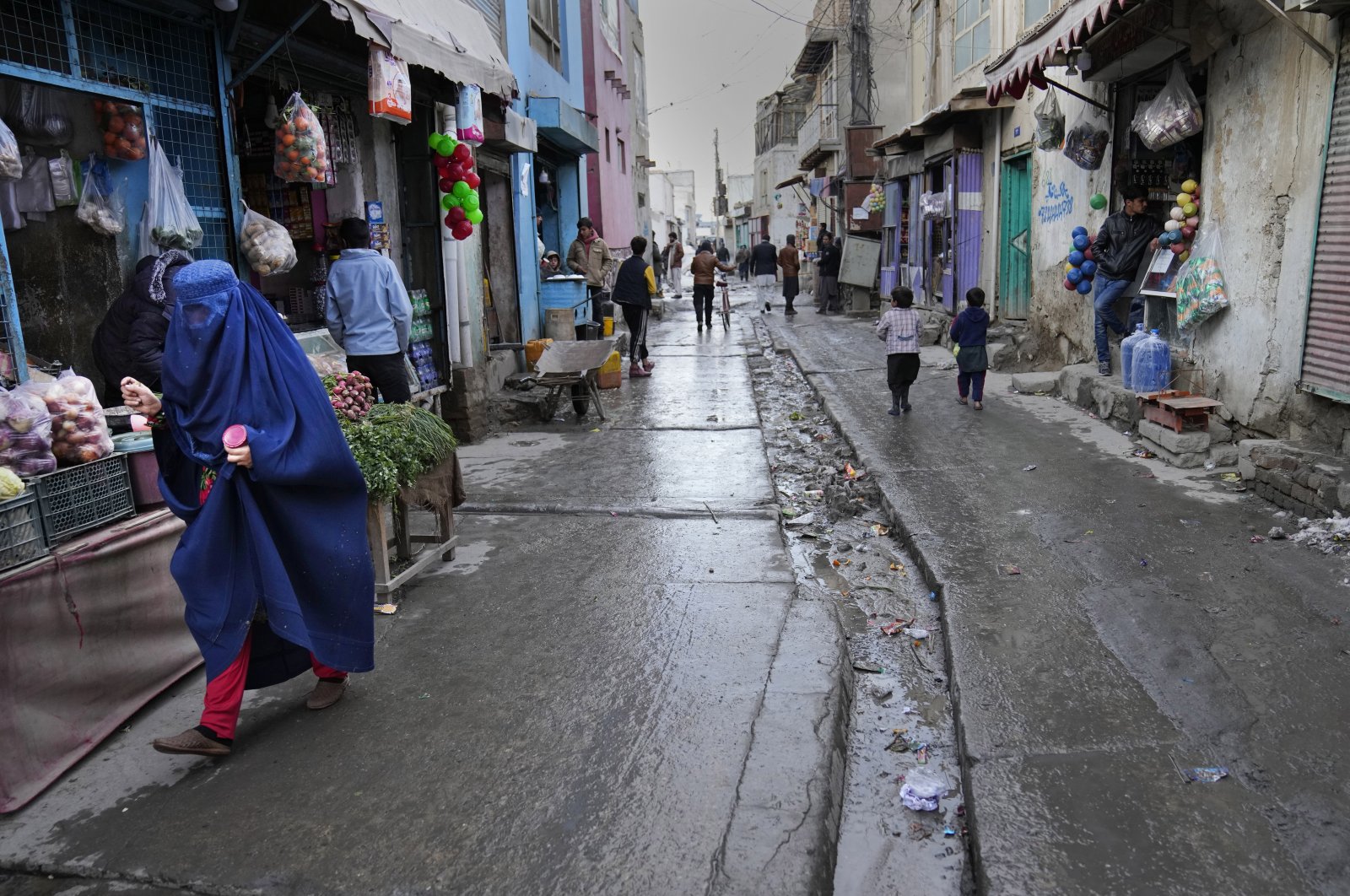 People shop in a market street, in Kabul, Afghanistan, Feb. 8, 2022. (AP Photo)
