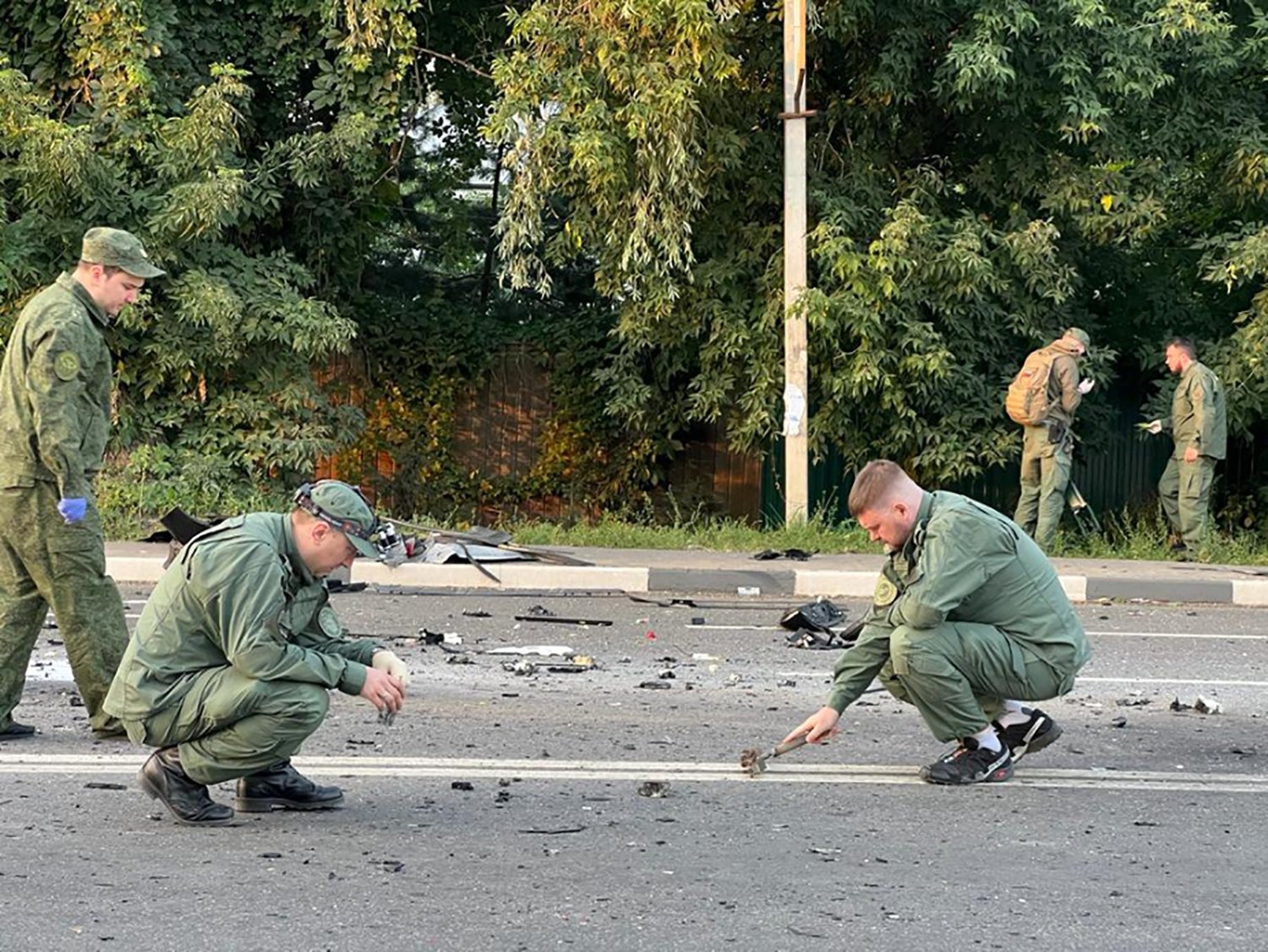 Investigators work at the place of an explosion of a car driven by Daria Dugina, the daughter of Alexader Dugin, a hardline Russian ideologue close to President Vladimir Putin, outside Moscow, Russia, Aug. 21, 2022. (AFP Photo)