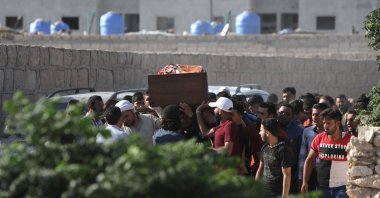 Mourners carry a coffin during a funeral for people killed in reported artillery fire by Syrian regime forces, in the opposition-held city of al-Bab, on the border with Türkiye in the northern Aleppo province, Syria, Aug. 19, 2022. (AFP Photo)