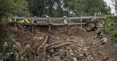 The railing of a small bridge is unhinged after a landslide caused by intense monsoon rains in Dharmsala, Himachal Pradesh state, India, Aug. 21, 2022. (AP Photo)