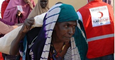 A woman carries aid delivered by the Turkish Red Crescent, in Juba, South Sudan, April 8, 2022. (AA PHOTO)