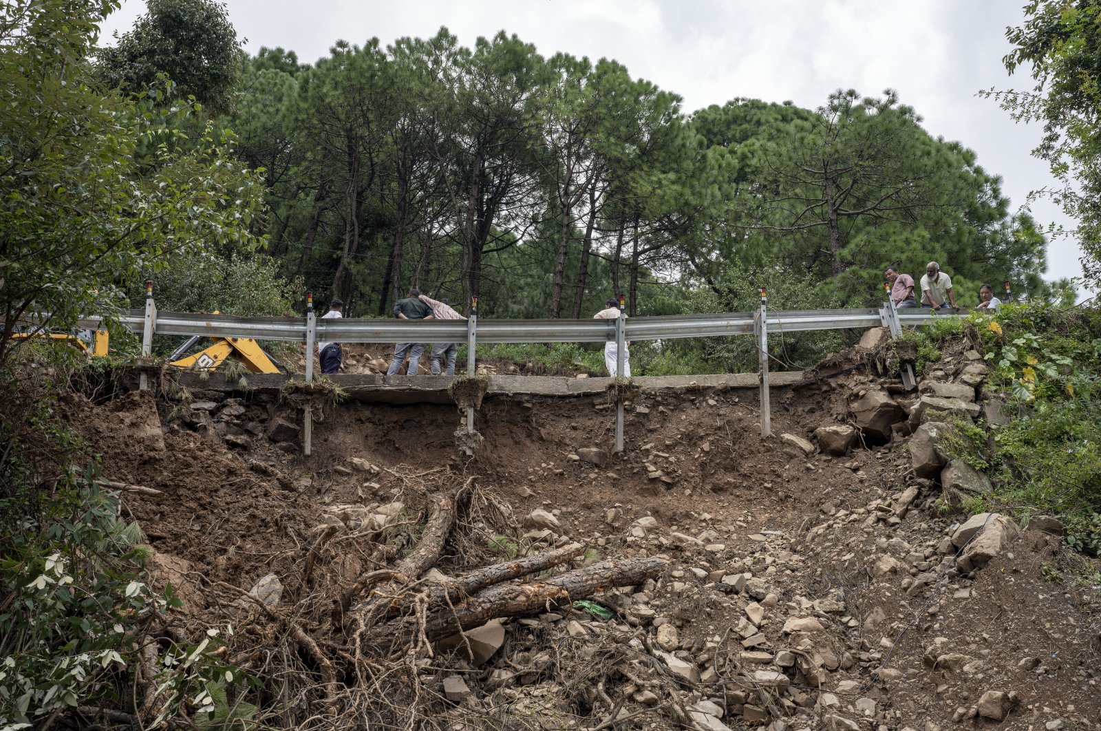 The railing of a small bridge is unhinged after a landslide caused by intense monsoon rains in Dharmsala, Himachal Pradesh state, India, Aug. 21, 2022. (AP Photo)