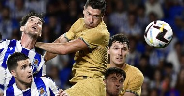 Barcelona's Robert Lewandowski (C) jumps for a header during a La Liga match against Real Sociedad, San Sebastian, Spain, Aug. 21, 2022. (AP Photo)