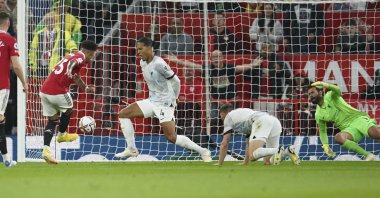 Manchester United's Jadon Sancho scores his side's first goal during the English Premier League soccer match between Manchester United and Liverpool at Old Trafford stadium, in Manchester, England, Aug. 22, 2022. (AP Photo)