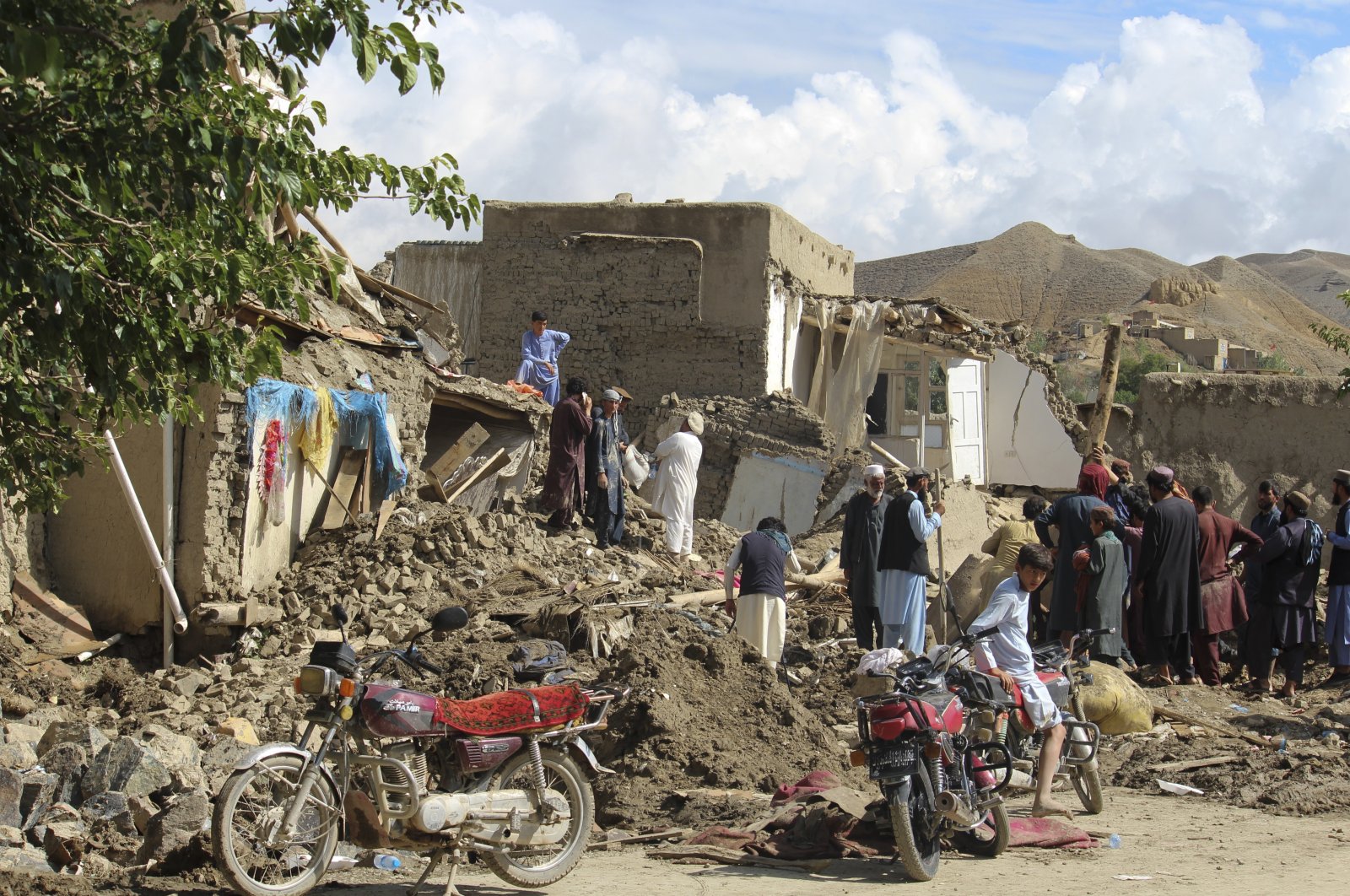 People clean up their damaged homes after heavy flooding in the Khushi district of Logar province south of Kabul, Afghanistan, Aug. 21, 2022. (AP Photo)