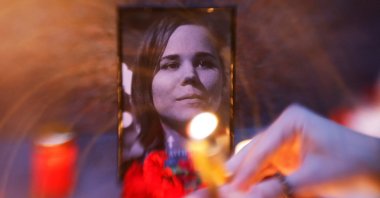 Flowers and candles are placed next to a portrait of media commentator Darya Dugina, who was killed in a car bomb attack, in Moscow, Russia August 22, 2022. REUTERS/Maxim Shemetov