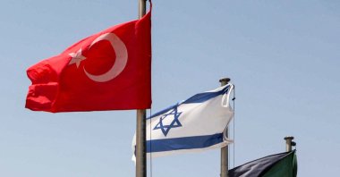The flags of Türkiye (L) and Israel (C) fly at a war memorial in Latrun, about 30 kilometers west of Jerusalem, Israel, Aug. 18, 2022. (AFP)