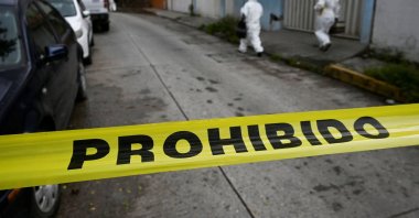 Members of a forensic team walk near a crime scene where journalist Fredid Roman was killed in his car by armed attackers on a motorcycle in Chilpancingo, Guerrero state, Mexico, Aug. 22, 2022.  (Reuters Photo)