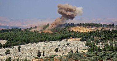 Smoke billows at the site of a reported Russian strike in a forest area west of Syria's opposition-held northwestern city of Idlib, on August 22, 2022. (Photo by Muhammad HAJ KADOUR / AFP)