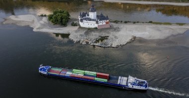 A container ships passes Pfalzgrafenstein castle in the middle of the river Rhine in Kaub, Germany, Aug. 12, 2022. (AP Photo)