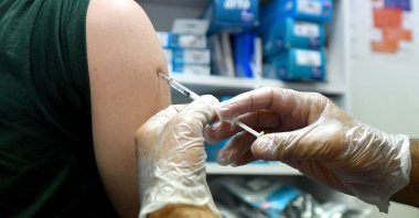 A pharmacist administers a dose of Imvanex, a vaccine to protect against the monkeypox virus, at a pharmacy in Lille, northern France, Aug. 10, 2022. (AFP Photo)